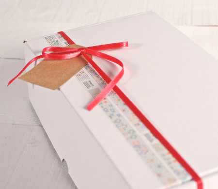 Box decorated with washi tape and red ribbon