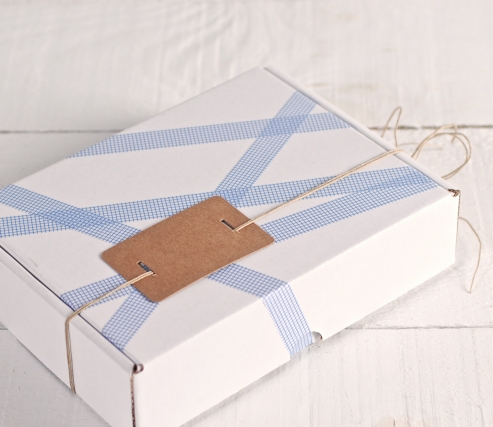 White box decorated with blue squares washi tape